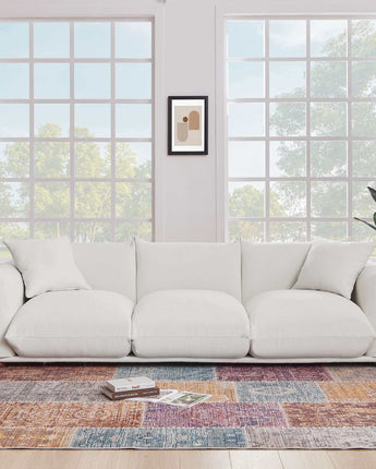 Elegant White boucle upholstered sofa with a soft, textured fabric in a neutral tone.