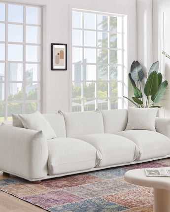 Cozy boucle upholstered sofa with a durable, tactile fabric in a light color.