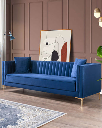 Dark blue velvet sofa with tufted backrest and gold accents.