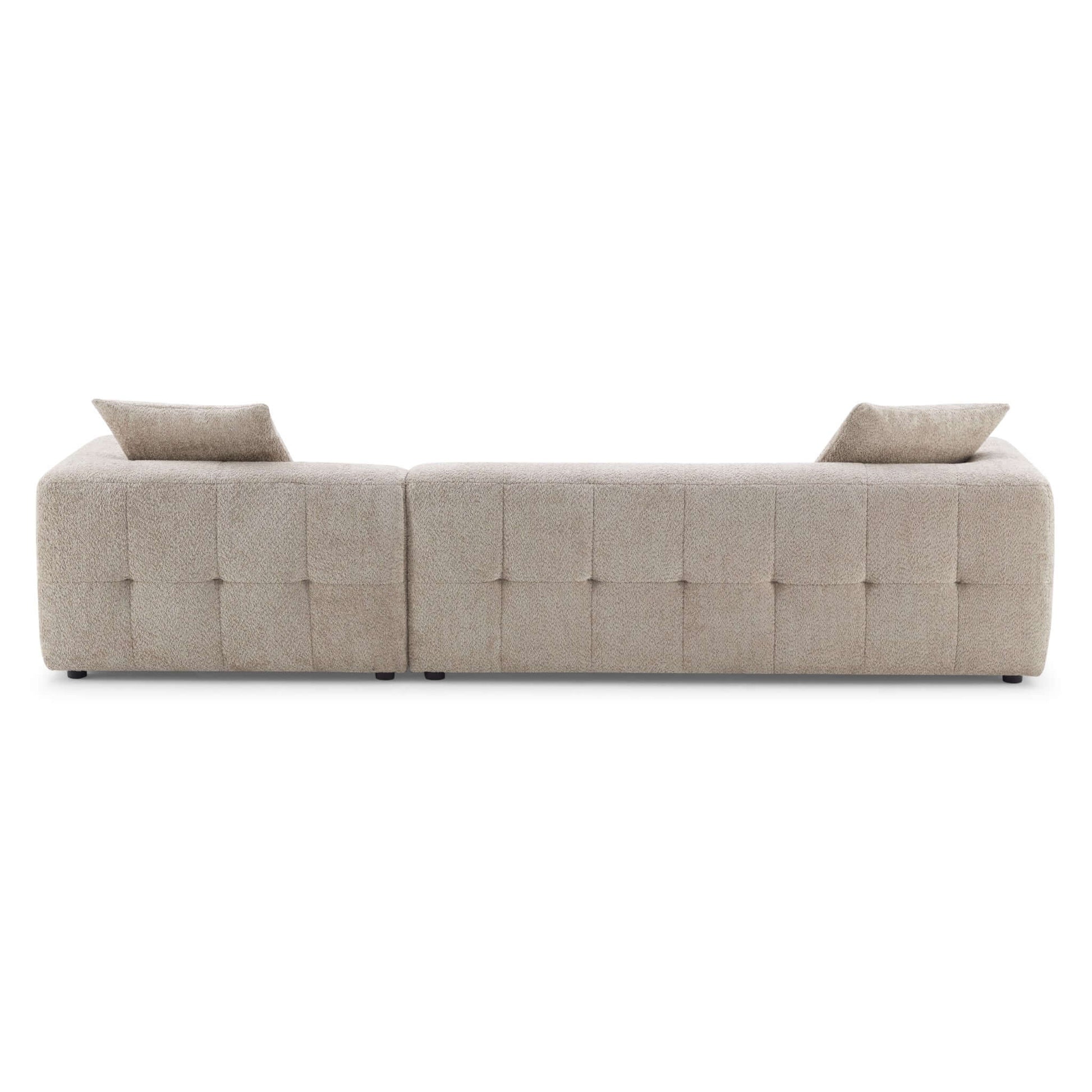 Kaynes Elegant boucle sectional with tufted back cushions.