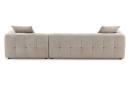 Kaynes Elegant boucle sectional with tufted back cushions.