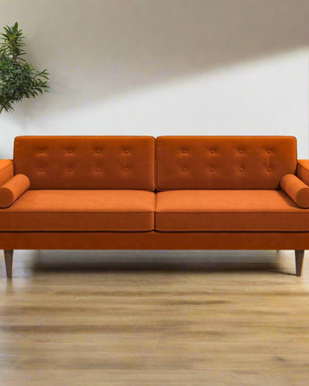 asey burnt orange sofa with a modern design in a cozy living room.